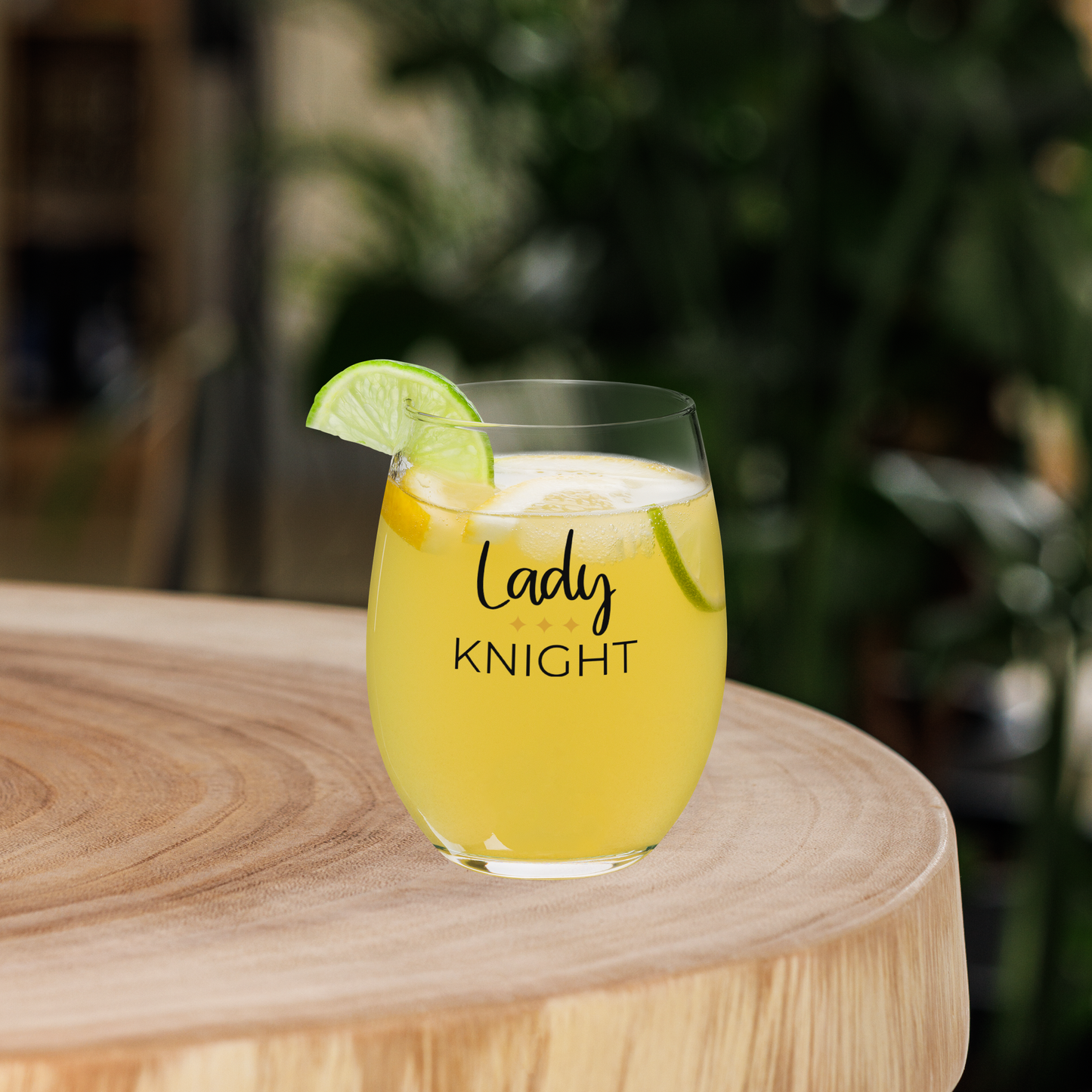 Lady Knight Stemless Wine Glass filled with a refreshing drink, garnished with lime.